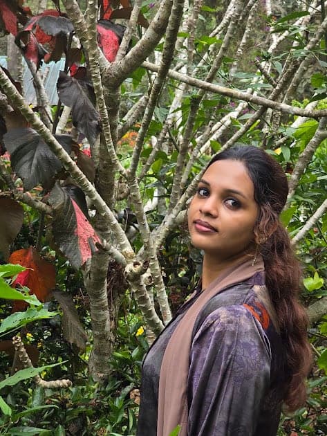 Fazna among trees and red flowers